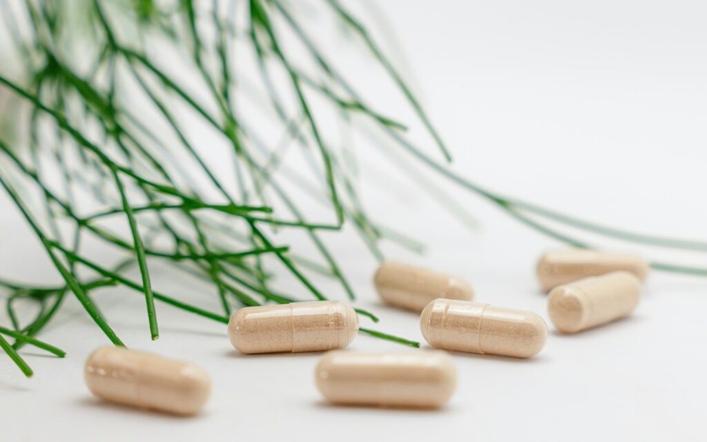 Illustrative supplement packaging representing the choice between herbal tablet and capsule formats; not a Brahmi product photograph